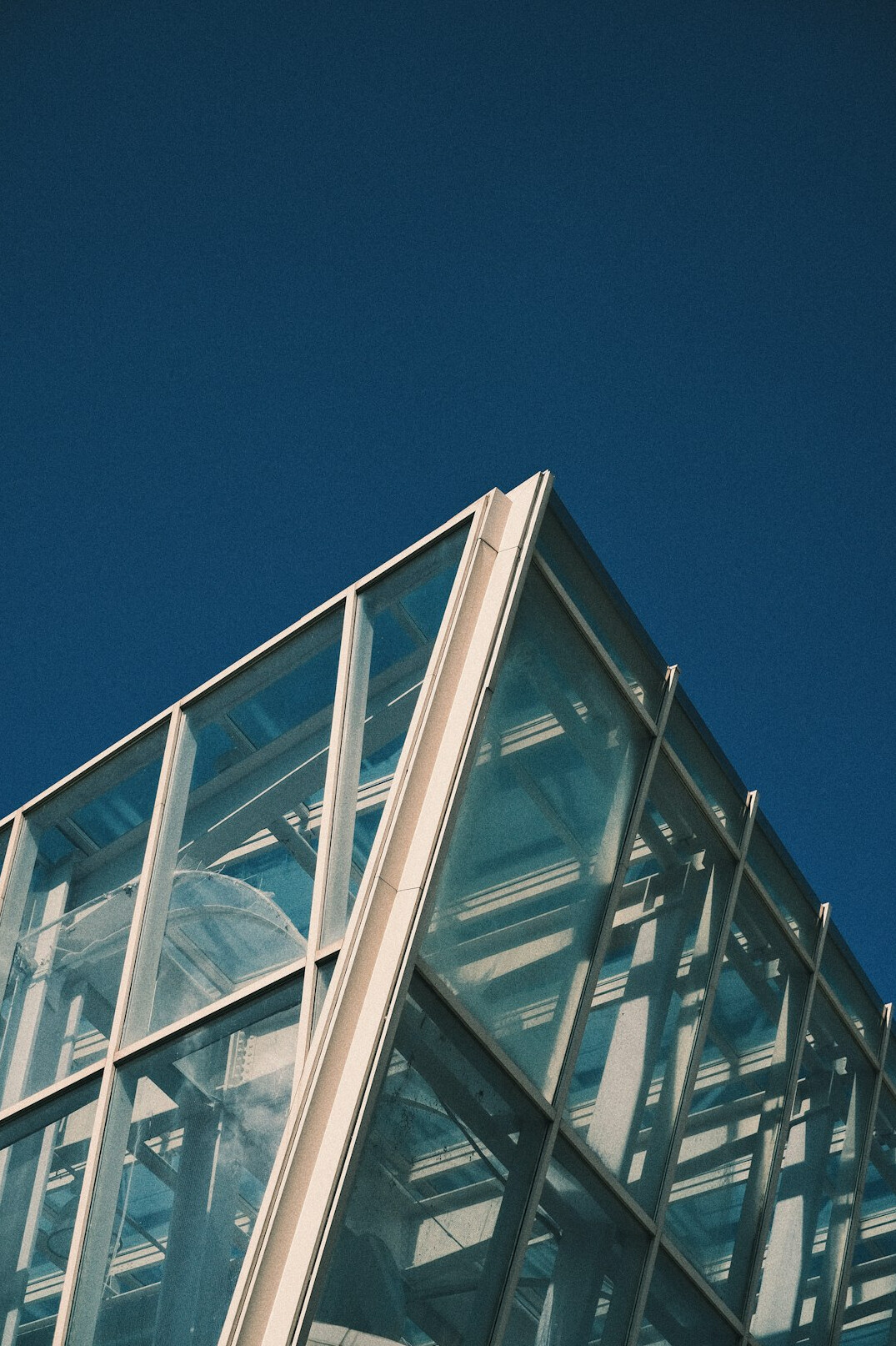 Modern glass office building exterior under a clear sky